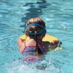 Young girl learning to swim on the French Riviera